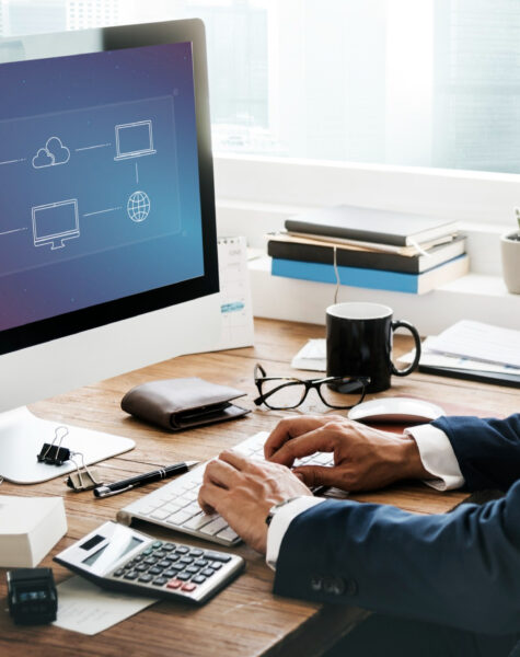 A man in suit and tie working on computer.