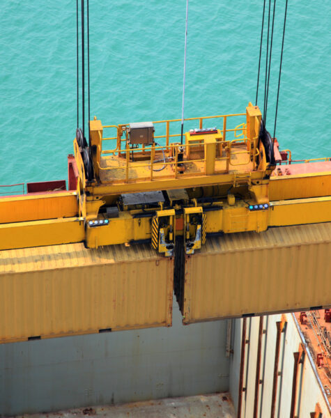 A crane lifting cargo from the ocean.