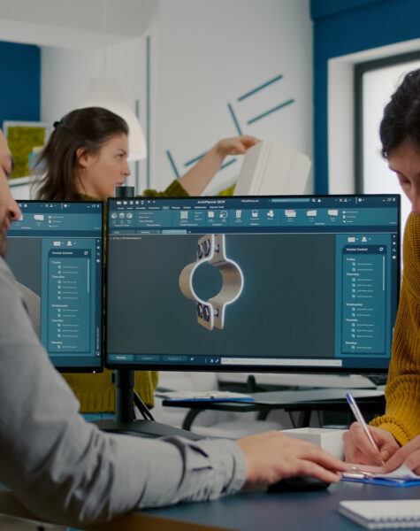 A man and woman working on a computer.