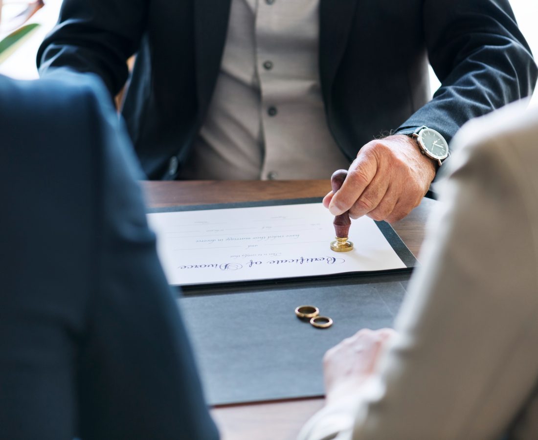 A man in suit and tie holding out his hand.